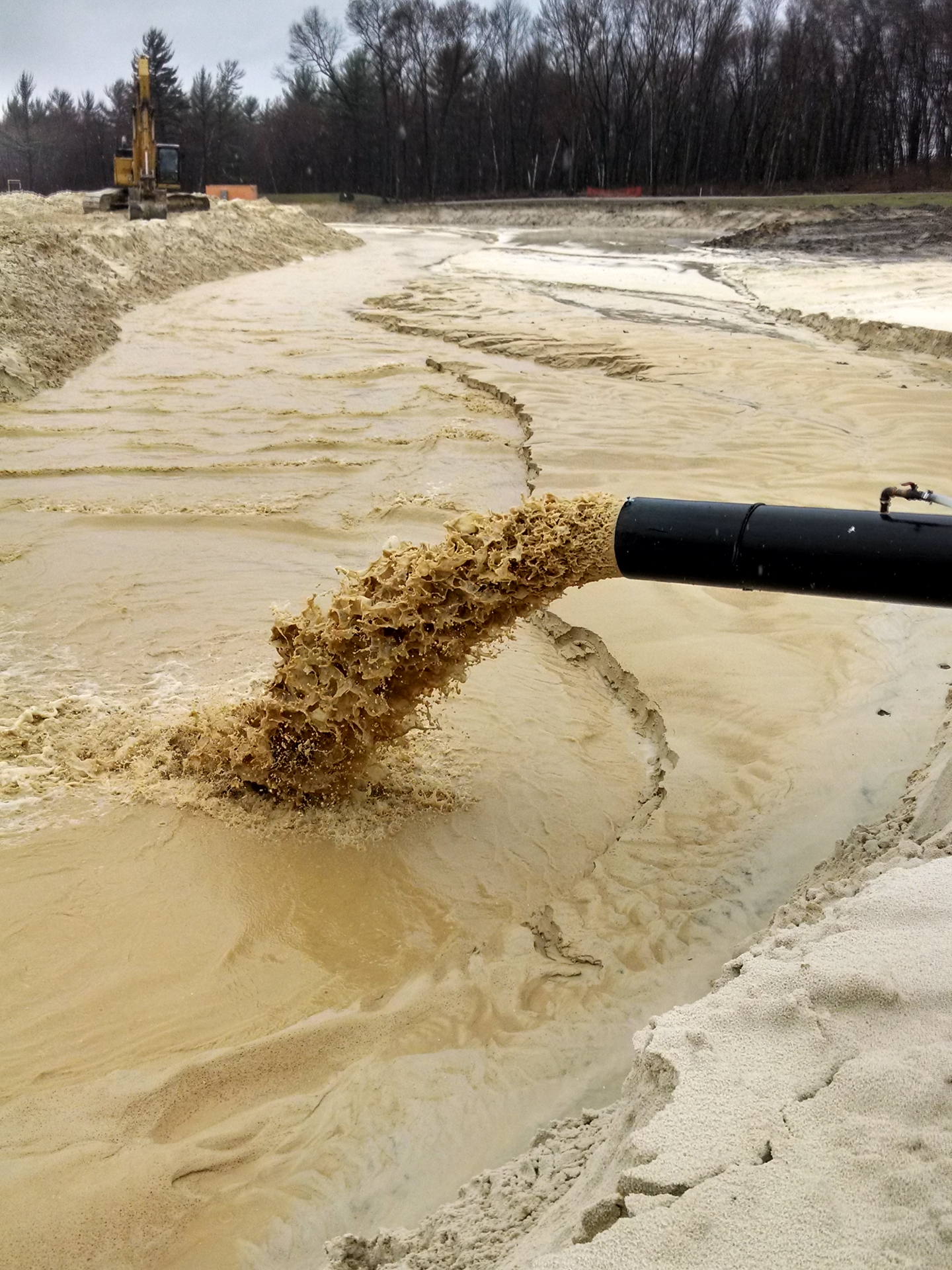 Wash water for an industrial sand washing plant is discharged into a settling basin.