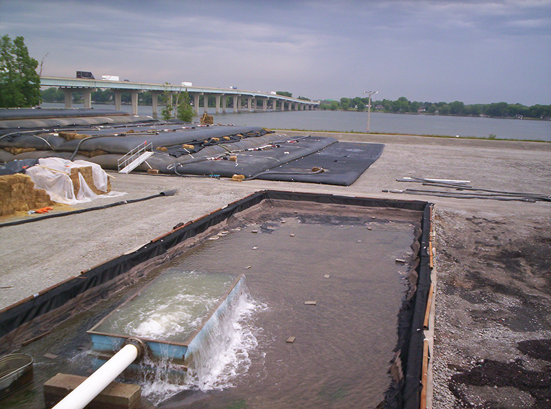 Treated water at an environmental clean-up site is pumped into dewatering bags.