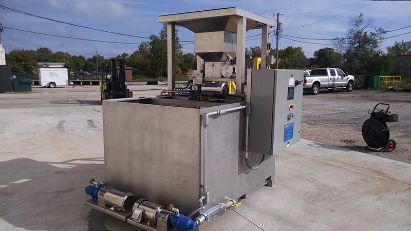 Une photo de l’A.P.I. en acier inoxydable modèle 300 de Clearwater Industries avec son système d’alimentation et de pompage du bac à grand sac à la trémie.