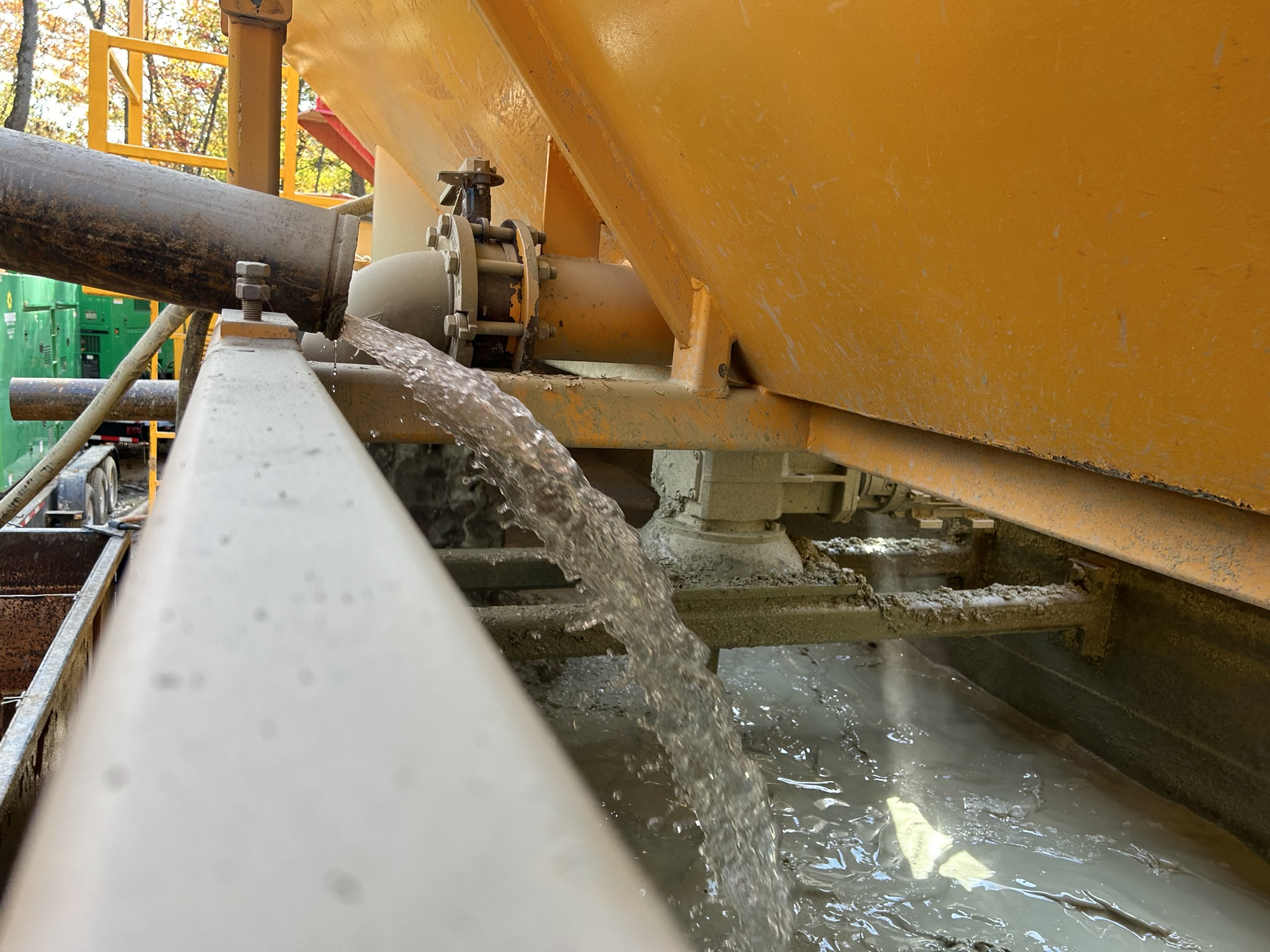 Centrate falling from a pipe into a tank.